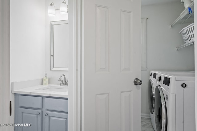 19 Runnel Dr, Colonie, NY 12304 - washroom featuring washer and clothes dryer, marble look tiles, cabinet space, and baseboards