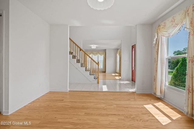 19 Runnel Dr, Colonie, NY 12304 - foyer entrance with stairway, baseboards, and light wood-style flooring