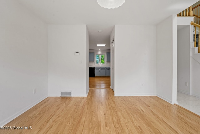 19 Runnel Dr, Colonie, NY 12304 - unfurnished room with stairway, light wood-style floors, and baseboards