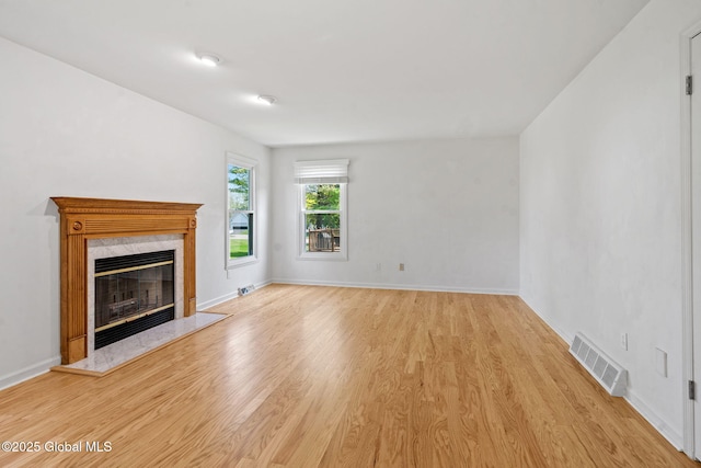 19 Runnel Dr, Colonie, NY 12304 - unfurnished living room with light wood-style floors, a fireplace, and baseboards