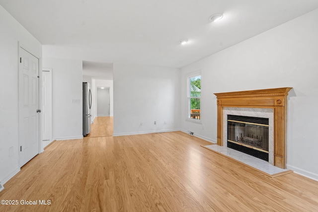 19 Runnel Dr, Colonie, NY 12304 - unfurnished living room with light wood-style floors, a fireplace, and baseboards