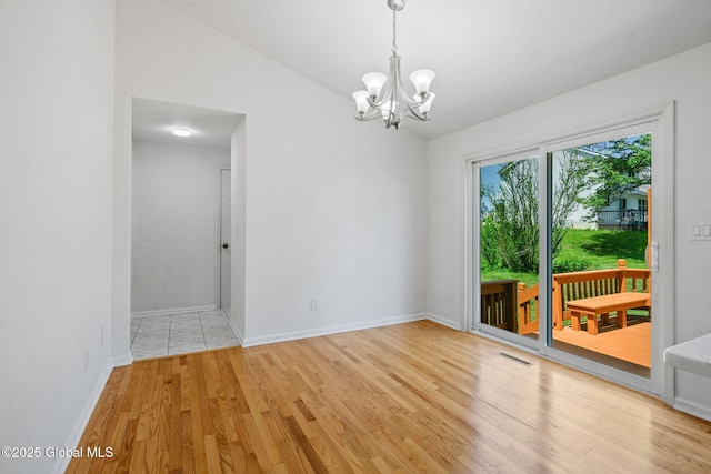 19 Runnel Dr, Colonie, NY 12304 - unfurnished room with a chandelier, light wood finished floors, baseboards, and lofted ceiling