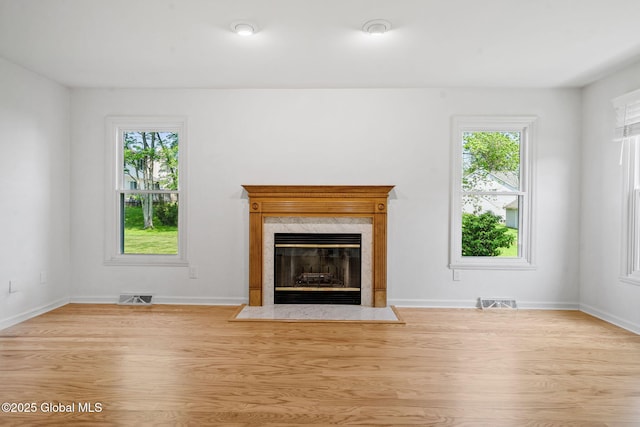 19 Runnel Dr, Colonie, NY 12304 - unfurnished living room featuring healthy amount of natural light, wood finished floors, a fireplace, and baseboards