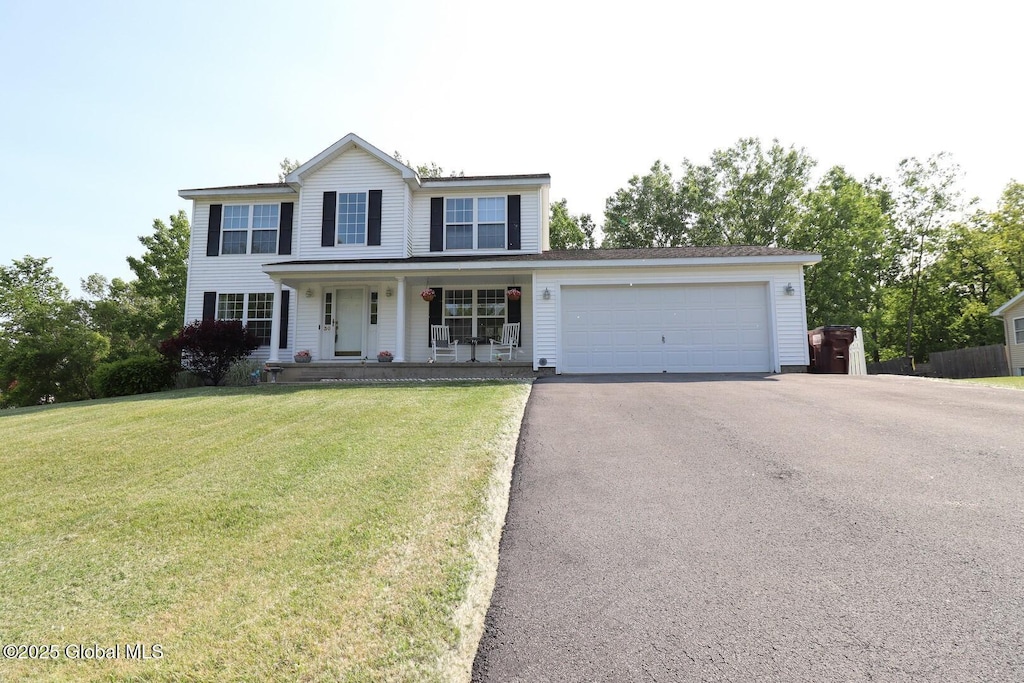 30 Battery Blvd, Stillwater, NY 12118 - view of front of property featuring covered porch, asphalt driveway, a garage, and a front lawn