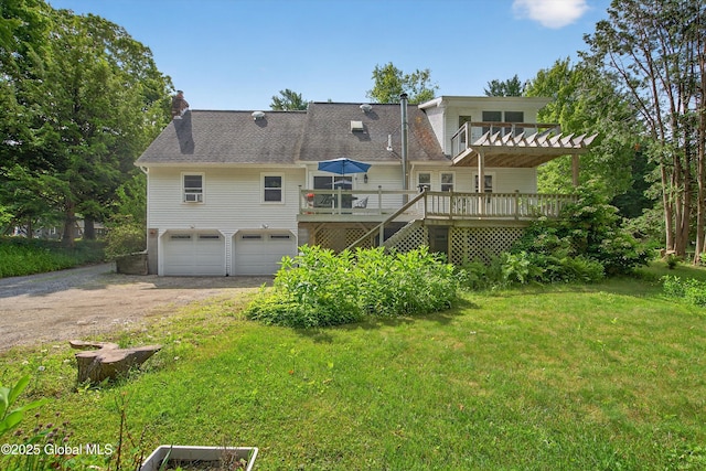 21 Hemlock Dr, Greenfield, NY 12833 - rear view of house featuring driveway, a deck, a chimney, a garage, and a lawn