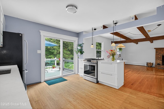 21 Hemlock Dr, Greenfield, NY 12833 - kitchen with appliances with stainless steel finishes, light wood-type flooring, light countertops, a baseboard heating unit, and beam ceiling