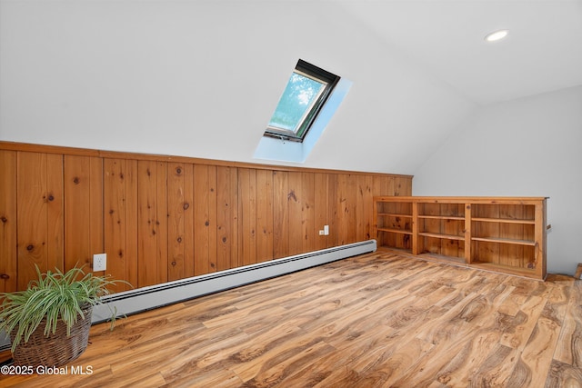 21 Hemlock Dr, Greenfield, NY 12833 - additional living space featuring a skylight, baseboard heating, wood finished floors, vaulted ceiling, and wooden walls