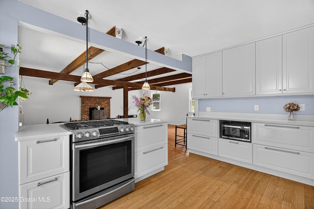 21 Hemlock Dr, Greenfield, NY 12833 - kitchen with appliances with stainless steel finishes, light countertops, beamed ceiling, white cabinetry, and light wood-style flooring