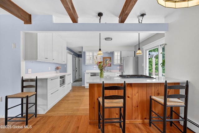 21 Hemlock Dr, Greenfield, NY 12833 - kitchen featuring freestanding refrigerator, beam ceiling, light wood-type flooring, white cabinetry, and light countertops