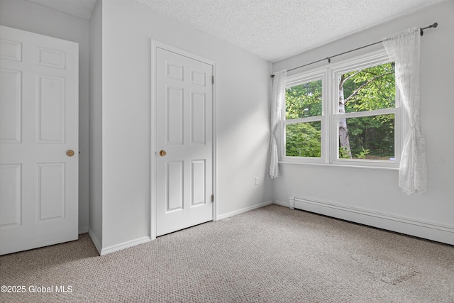 21 Hemlock Dr, Greenfield, NY 12833 - unfurnished bedroom with carpet floors, baseboard heating, and a textured ceiling
