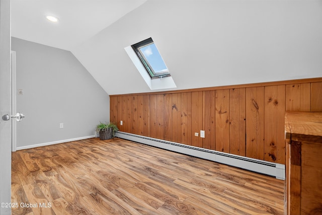 21 Hemlock Dr, Greenfield, NY 12833 - additional living space with a skylight, baseboard heating, vaulted ceiling, wood finished floors, and wood walls