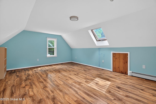 21 Hemlock Dr, Greenfield, NY 12833 - bonus room featuring a skylight, wood finished floors, vaulted ceiling, healthy amount of natural light, and a baseboard heating unit