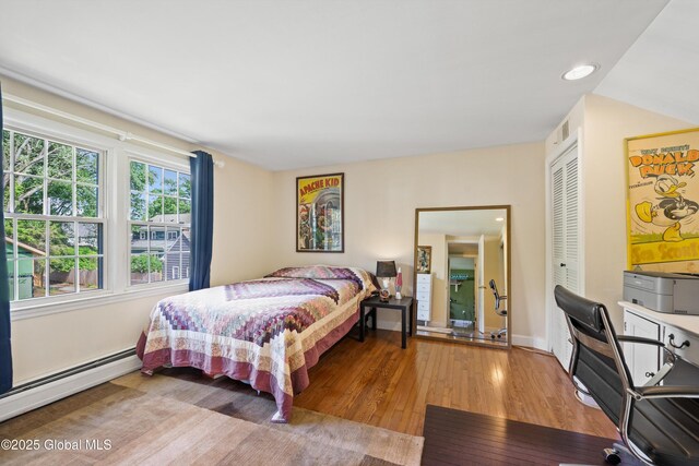 38 Horicon Ave, Glens Falls, NY 12801 - bedroom featuring wood-type flooring, a baseboard radiator, a closet, and recessed lighting