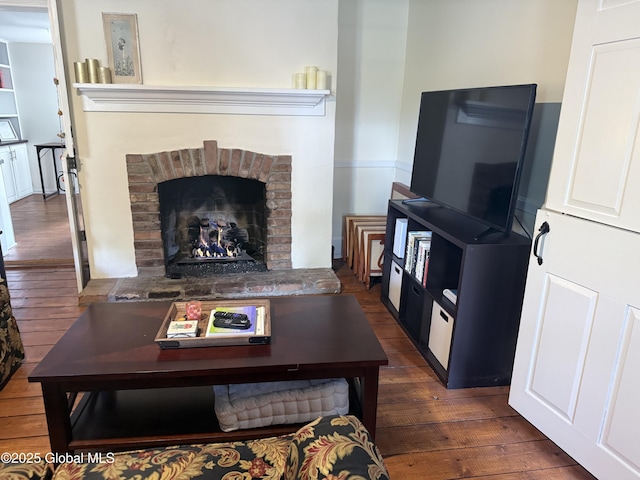 304 Green St, Schenectady, NY 12305 - living area with dark wood finished floors and a brick fireplace
