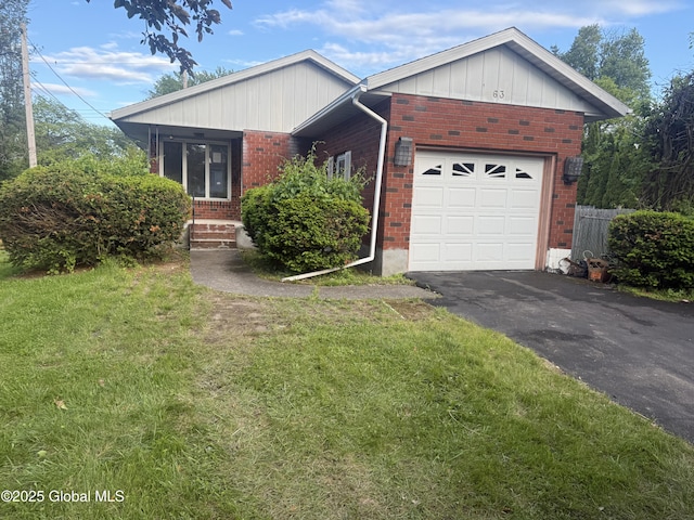 63 Ormond St, Albany, NY 12203 - view of front of property with brick siding, an attached garage, a front yard, asphalt driveway, and board and batten siding