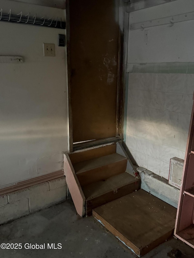 63 Ormond St, Albany, NY 12203 - staircase featuring unfinished concrete flooring