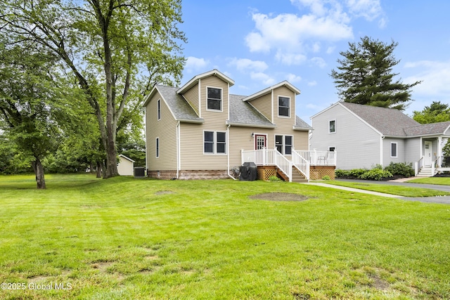 7 Camp Ter, Guilderland, NY 12203 - view of front facade with a shingled roof, a front yard, and a wooden deck
