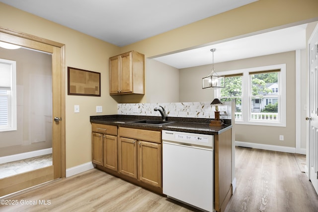 7 Camp Ter, Guilderland, NY 12203 - kitchen featuring white dishwasher, light wood-type flooring, tasteful backsplash, and dark countertops