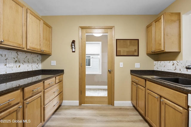 7 Camp Ter, Guilderland, NY 12203 - kitchen featuring light wood-style floors, decorative backsplash, and dark stone countertops