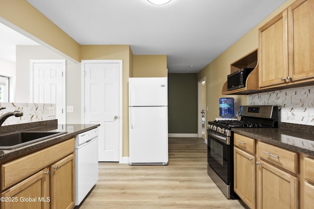 7 Camp Ter, Guilderland, NY 12203 - kitchen with appliances with stainless steel finishes, decorative backsplash, light wood-style floors, and dark stone counters