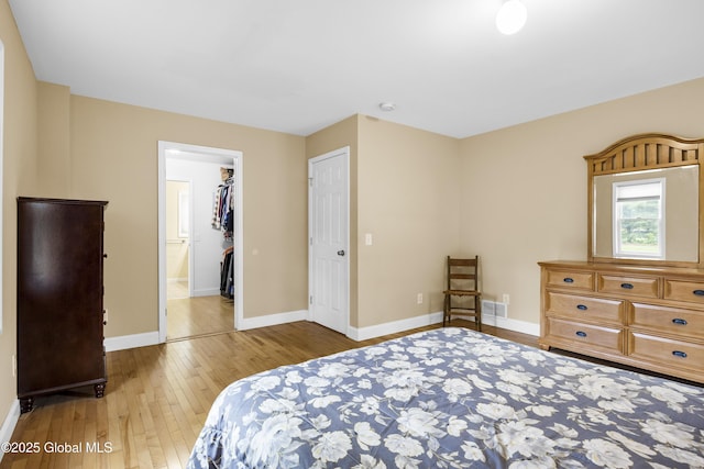 7 Camp Ter, Guilderland, NY 12203 - bedroom featuring hardwood / wood-style flooring and a walk in closet