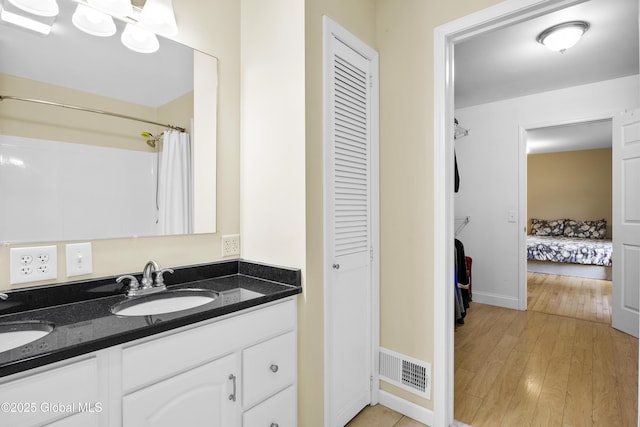 7 Camp Ter, Guilderland, NY 12203 - ensuite bathroom featuring a closet, double vanity, and wood finished floors