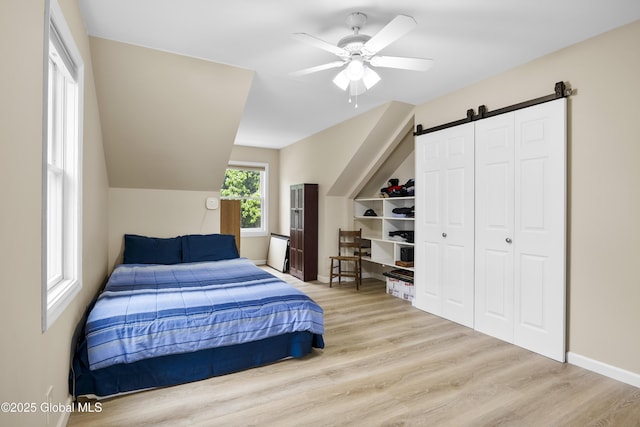 7 Camp Ter, Guilderland, NY 12203 - bedroom featuring wood finished floors, a barn door, ceiling fan, and a closet