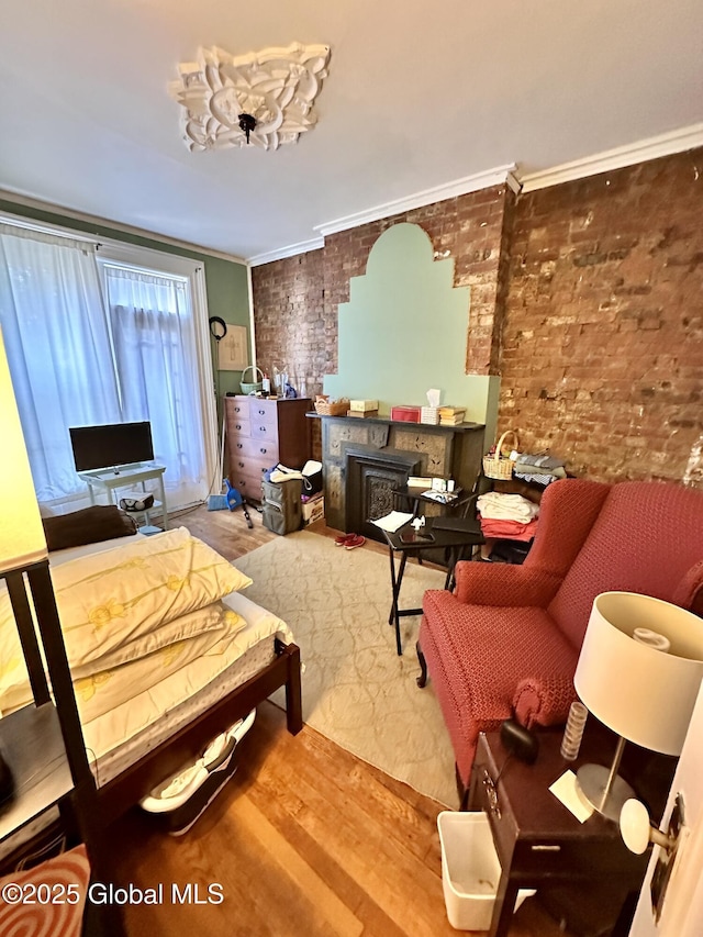 369 Madison Ave, Albany, NY 12210 - bedroom with wood finished floors, brick wall, and crown molding