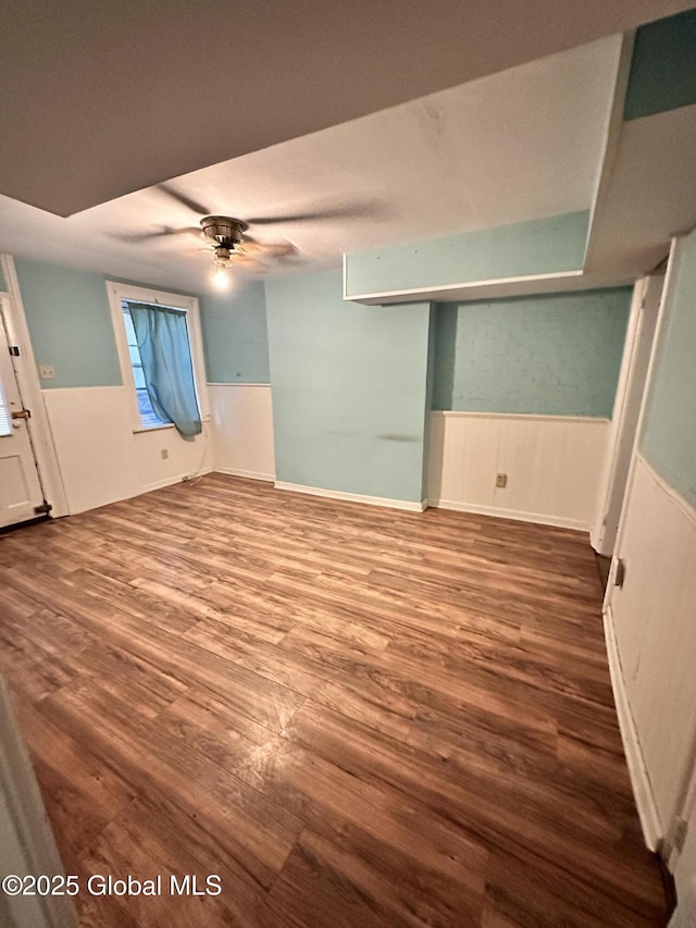 369 Madison Ave, Albany, NY 12210 - unfurnished bedroom with wainscoting, wood finished floors, and a ceiling fan
