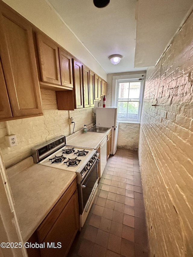 369 Madison Ave, Albany, NY 12210 - kitchen with white appliances, backsplash, brown cabinetry, dark tile patterned floors, and a sink