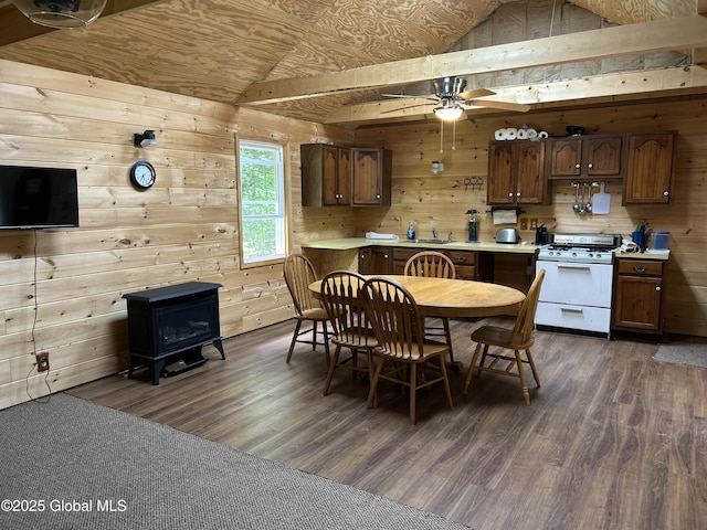 10 W Tucker Rd, Stony Creek, NY 12878 - dining area featuring a wood stove, wooden walls, a ceiling fan, vaulted ceiling, and dark wood-style flooring
