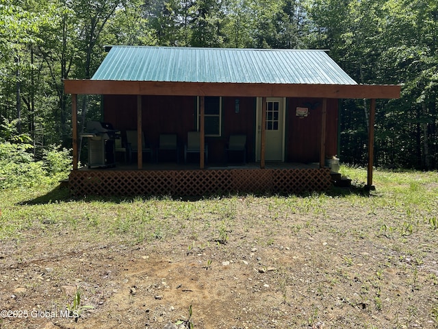 10 W Tucker Rd, Stony Creek, NY 12878 - view of front of home featuring metal roof, a porch, and a view of trees