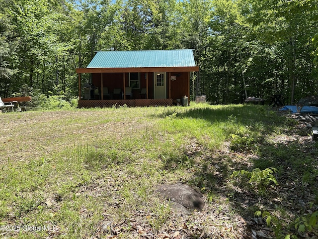 10 W Tucker Rd, Stony Creek, NY 12878 - view of front facade featuring metal roof, a view of trees, and a porch