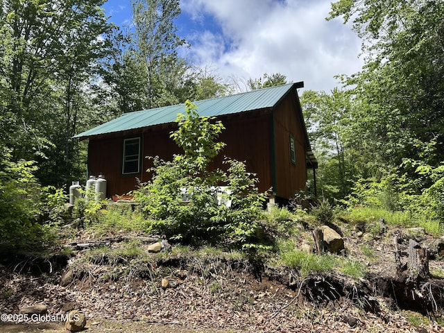 10 W Tucker Rd, Stony Creek, NY 12878 - view of side of home featuring metal roof and an outbuilding