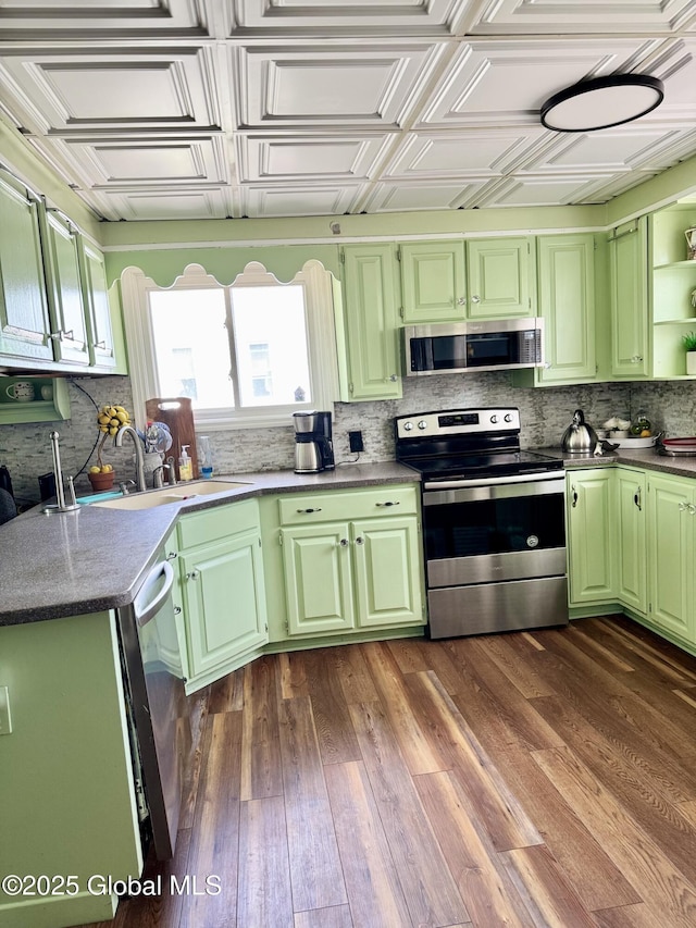 302 Pennsylvania Ave, Johnstown, NY 12095 - kitchen with stainless steel appliances, a sink, decorative backsplash, dark wood-type flooring, and open shelves