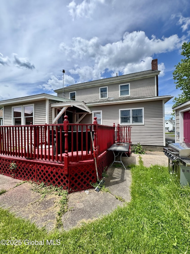 302 Pennsylvania Ave, Johnstown, NY 12095 - back of property with a chimney and a wooden deck