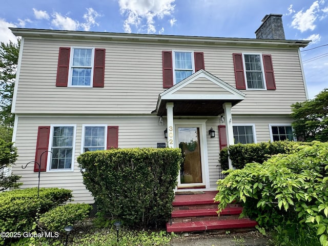 302 Pennsylvania Ave, Johnstown, NY 12095 - colonial house featuring a chimney