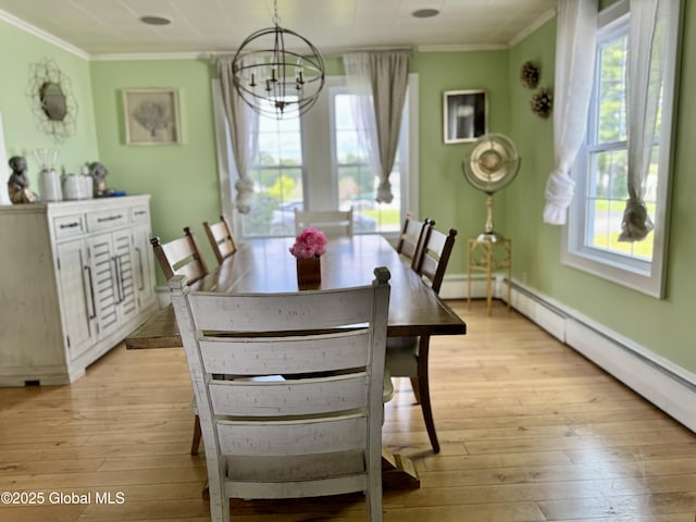 302 Pennsylvania Ave, Johnstown, NY 12095 - dining room featuring crown molding, light wood-style floors, a chandelier, baseboards, and a baseboard radiator