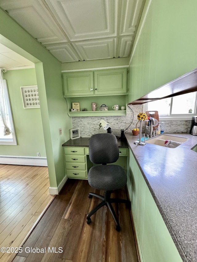 302 Pennsylvania Ave, Johnstown, NY 12095 - office with baseboard heating, a sink, built in desk, and dark wood-type flooring