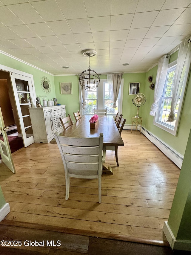302 Pennsylvania Ave, Johnstown, NY 12095 - dining area with ornamental molding, light wood-style flooring, plenty of natural light, a baseboard heating unit, and a chandelier