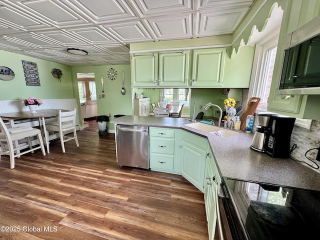 302 Pennsylvania Ave, Johnstown, NY 12095 - kitchen with stainless steel appliances, a sink, a peninsula, an ornate ceiling, and green cabinetry