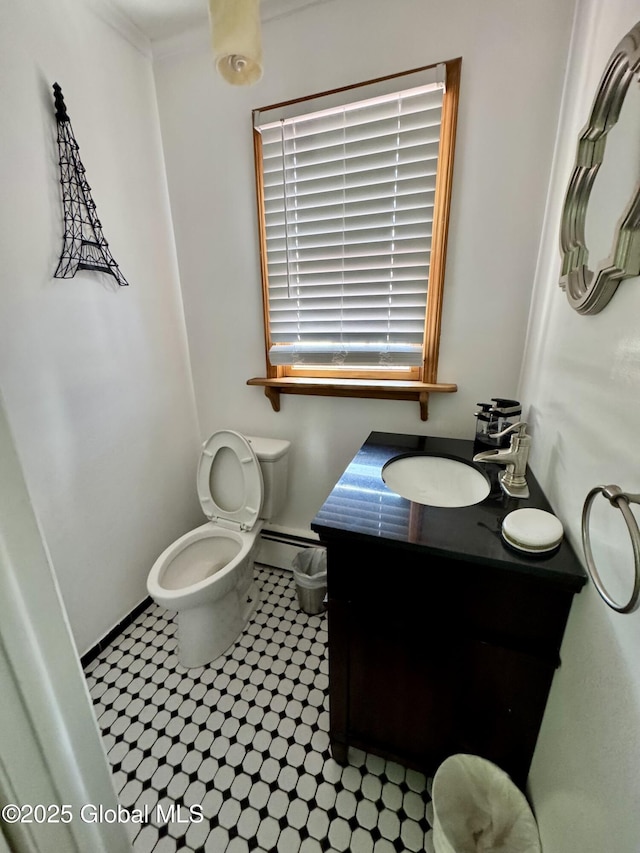 302 Pennsylvania Ave, Johnstown, NY 12095 - bathroom featuring toilet, vanity, baseboards, tile patterned flooring, and a baseboard radiator