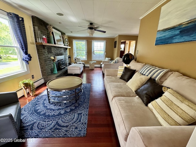 302 Pennsylvania Ave, Johnstown, NY 12095 - living area with ornamental molding, a ceiling fan, a fireplace, and wood finished floors