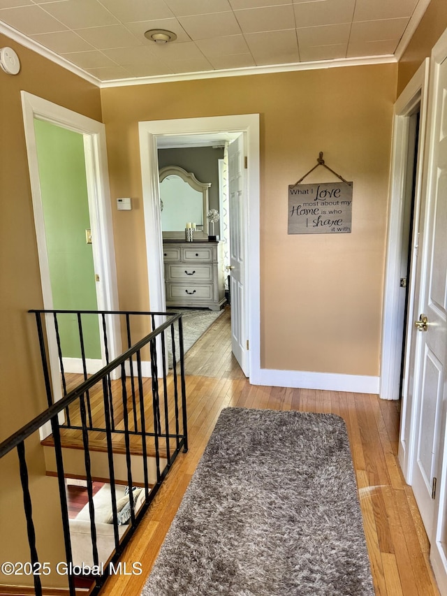 302 Pennsylvania Ave, Johnstown, NY 12095 - hallway with crown molding, an upstairs landing, wood-type flooring, and baseboards