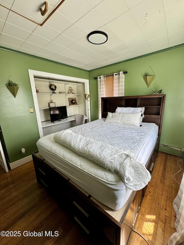 302 Pennsylvania Ave, Johnstown, NY 12095 - bedroom with hardwood / wood-style flooring, baseboards, and a baseboard radiator