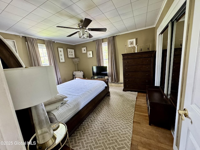 302 Pennsylvania Ave, Johnstown, NY 12095 - bedroom featuring crown molding, wood finished floors, multiple windows, and ceiling fan