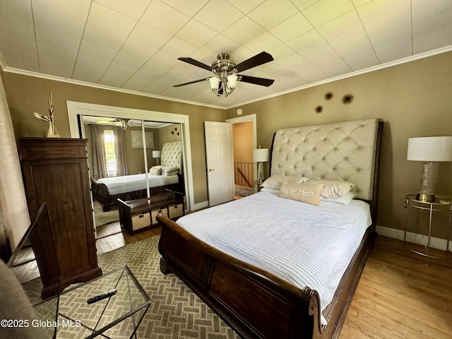 302 Pennsylvania Ave, Johnstown, NY 12095 - bedroom featuring crown molding, wood finished floors, baseboards, ceiling fan, and a closet