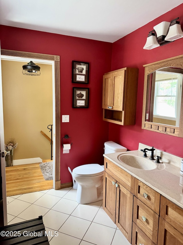 302 Pennsylvania Ave, Johnstown, NY 12095 - bathroom featuring vanity, toilet, tile patterned floors, and baseboards
