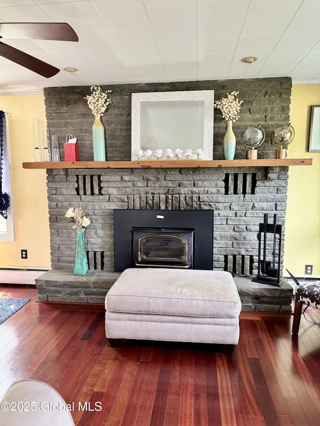302 Pennsylvania Ave, Johnstown, NY 12095 - living area with a fireplace, hardwood / wood-style floors, ceiling fan, ornamental molding, and a baseboard radiator