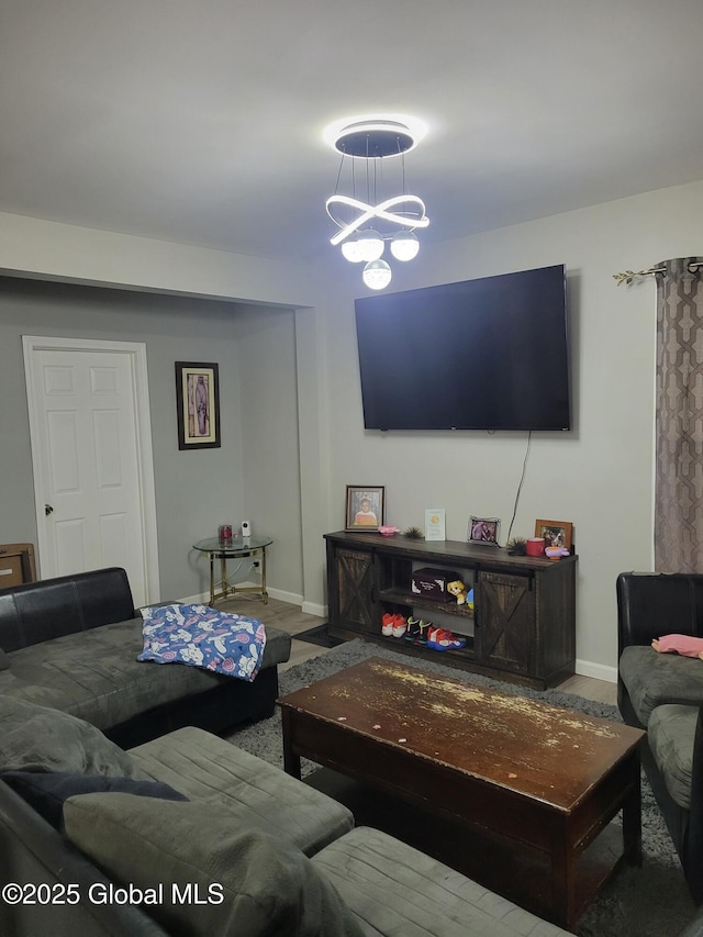 206 Catherine St, Scotia, NY 12302 - living area featuring baseboards and a chandelier